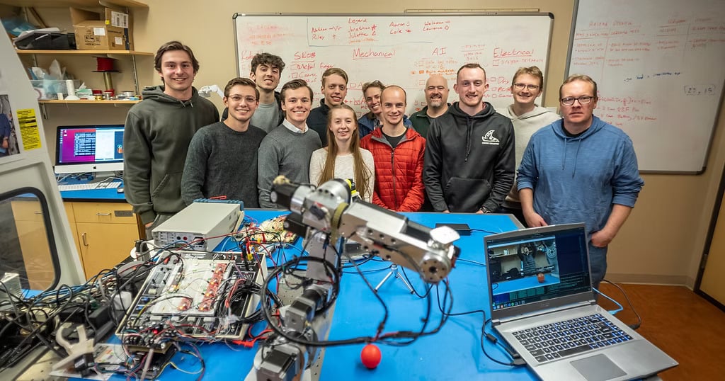 Students in a robotics class with the AR4 robot arm